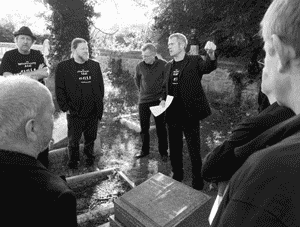 Men singing  at the grave of Alfred Williams.